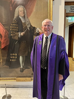 Dr DuBois poses in a purple robe at the Royal College of Physicians