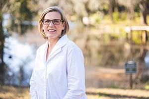portrait of a woman in a white lab coat