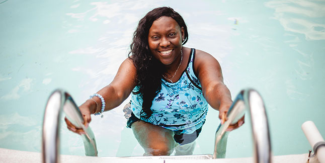 LaToya Wilson climbs up stairs out of a pool