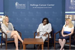 three women smile on a TV set