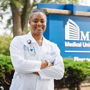 Demetress Adams-Ludd stands in front of MUSC Health Florence Medical Center sign