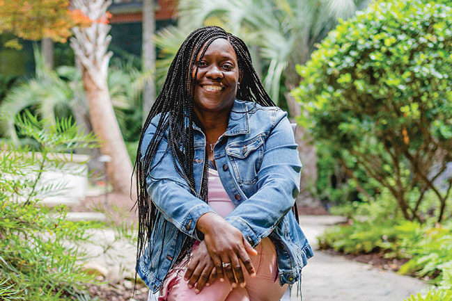 LaToya Wilson sits in the Hollings garden