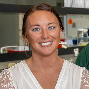 portrait of a smiling woman in a research lab
