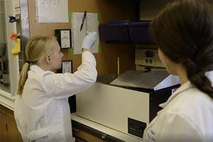 screenshot of two women working in the lab