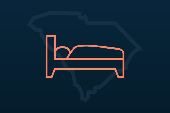 person lying in bed icon with outline of South Carolina behind it
