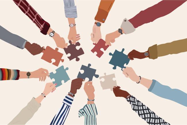 illustration showing a group of arms forming a circle with hands extended holding puzzle pieces into the middle