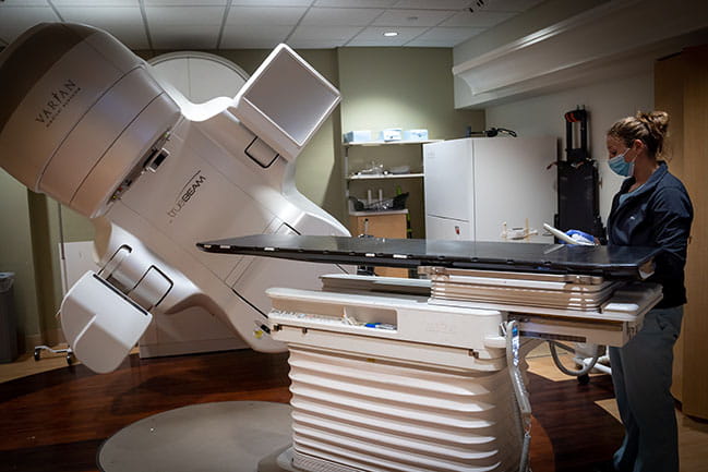 person operates true beam radiation therapy equipment