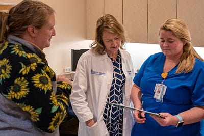 a doctor talks with two nurses