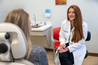 a doctor talks to a patient in a clinic room