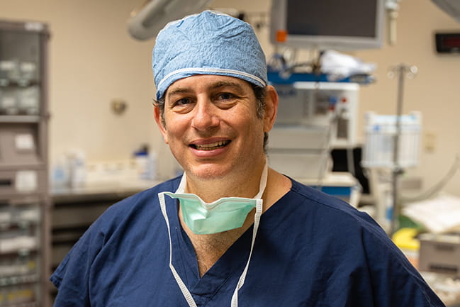 Dr. Jason Newman stands in an operating room