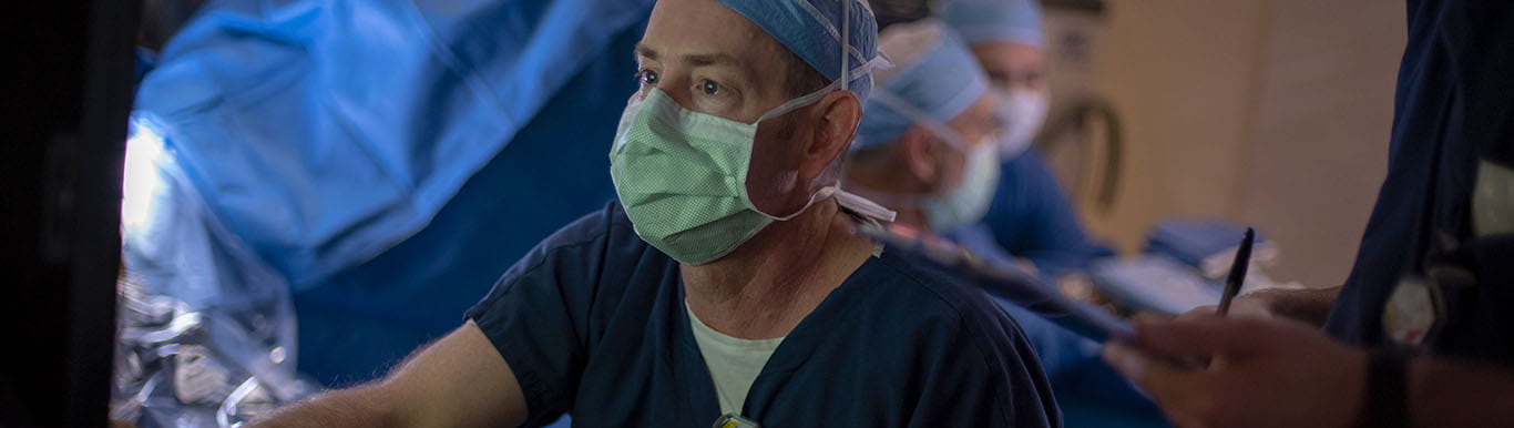 Dr. David Marshall looks at a computer screen in an operating room