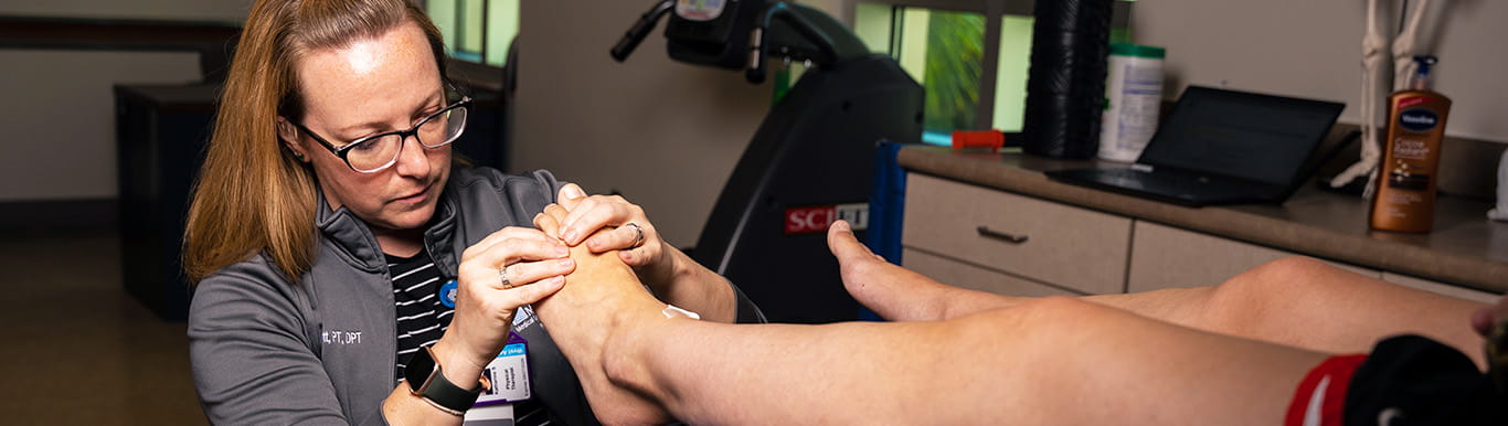 Dr. Katie Schmitt massages a patient's foot