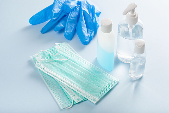 face masks, protective gloves and bottles of hand sanitizer