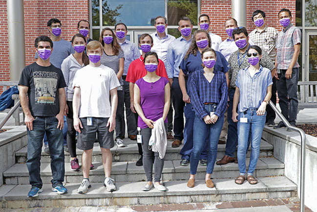 members of the Pancreatic Transdisciplinary Cancer Team stand outside with purple face masks on