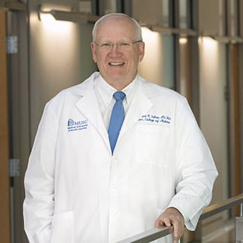 Dr. Raymond DuBois wearing a white physician's coat