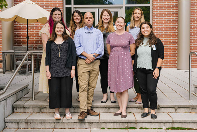 Team IMPACT staff stands outside