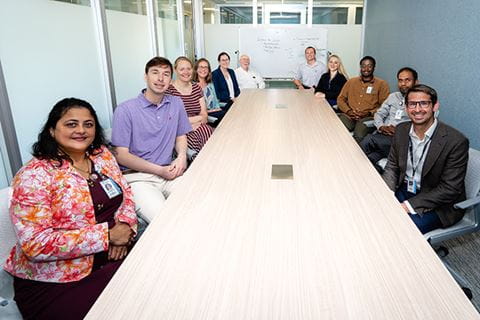 a large group of SCOR researchers sit around a conference table