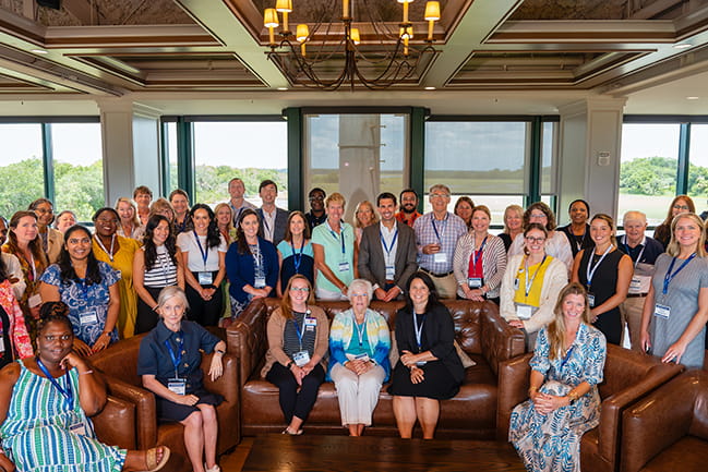 large group of attendees at the SCOR Symposium seated and standing