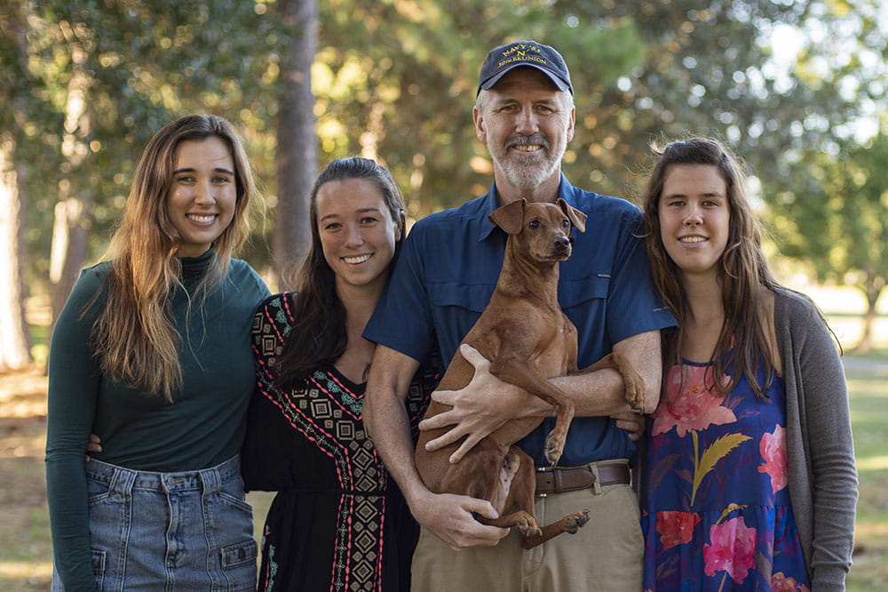Joe Coen poses with his three daughters Emma, Olivia and Meredith (left to right). Photo by Emma Vought.