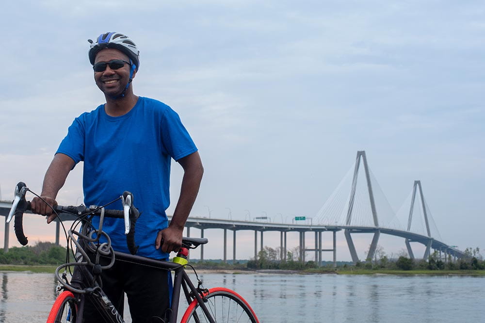Man on a bike in front of the Arthur Ravenel Jr. Bridge