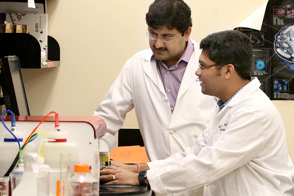 Dr. Shikhar Mehrotra works with a colleague in the lab