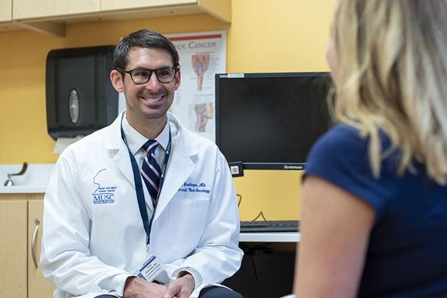 Dr. Evan Graboyes talks with a patient