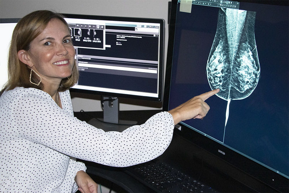 Dr. Rebecca Leddy points to a mammogram image on a computer screen
