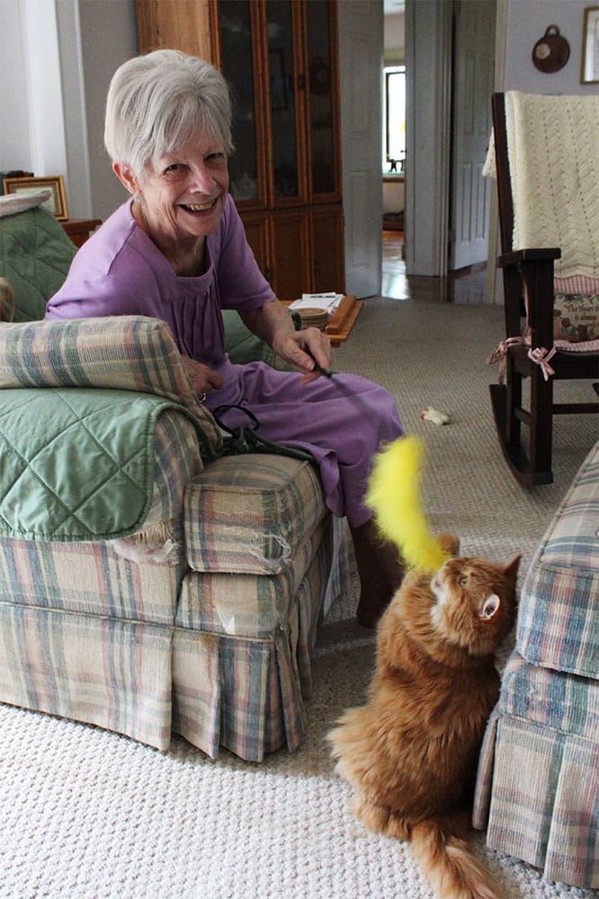 Janet Smith plays with her cat Moe