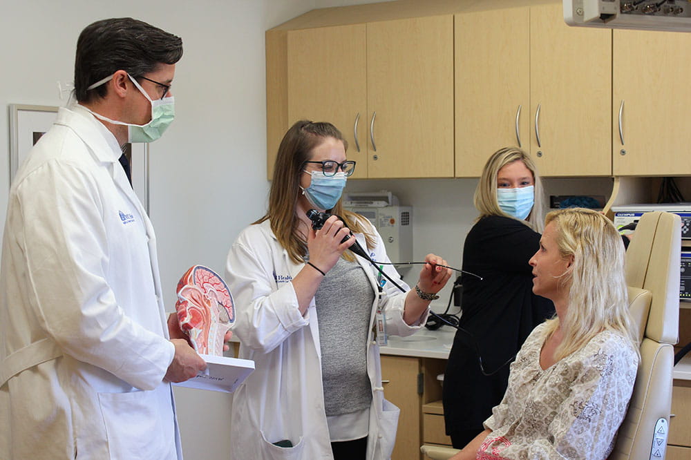 head and neck cancer care staff examine a patient