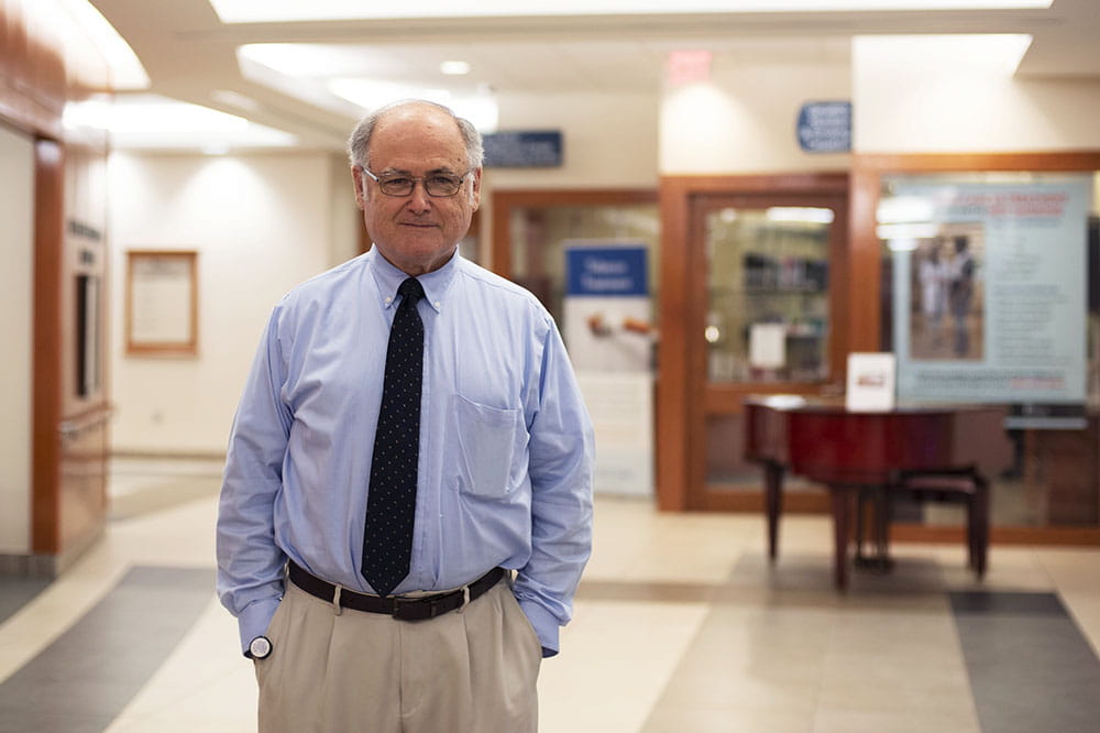 Dr. Michael Lilly stands in the lobby of Hollings Cancer Center
