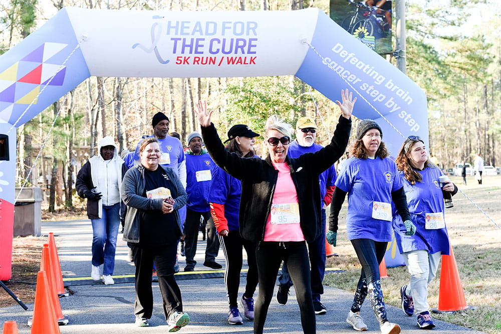 group of participants walk in the head for the cure event in 2020