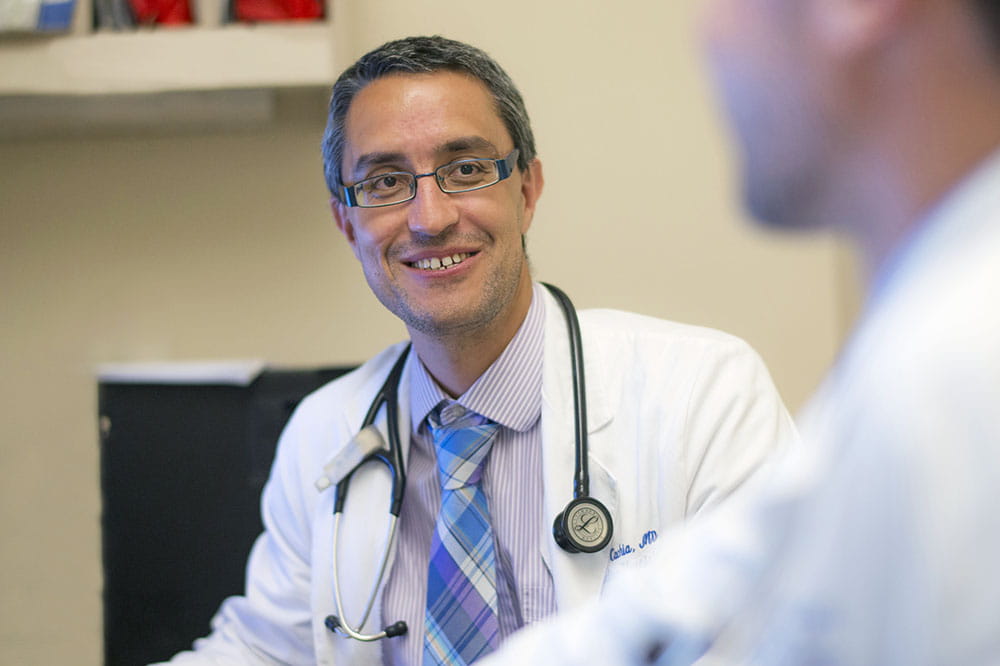 Dr. David Cachia talks with another doctor