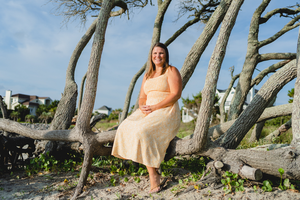 Jana Chanthabne sits on a tree at the Sullivan's Island Beach.