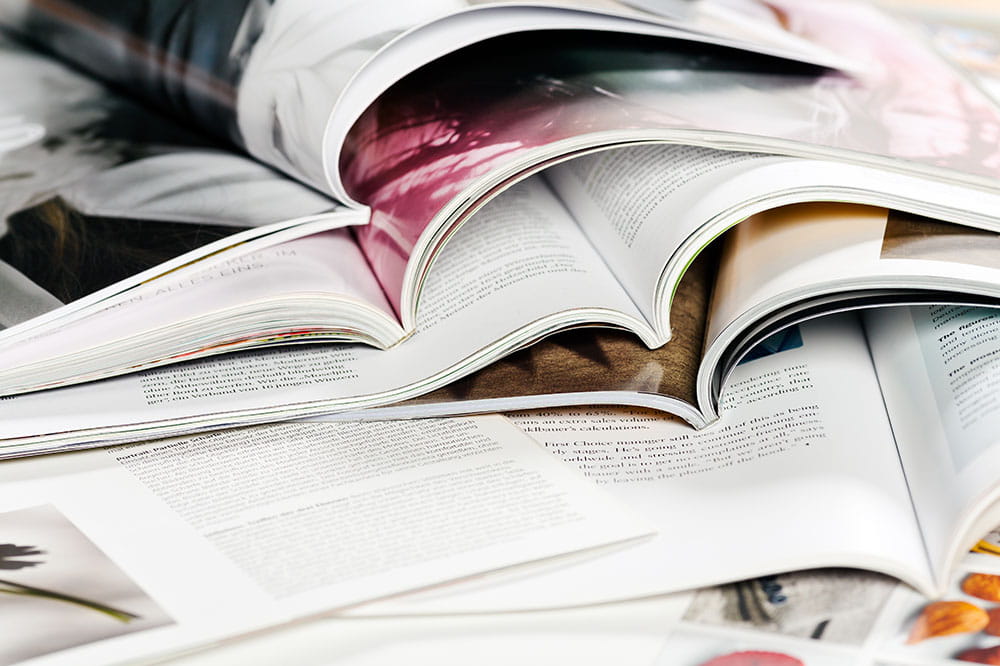 open magazines piled on top of each other