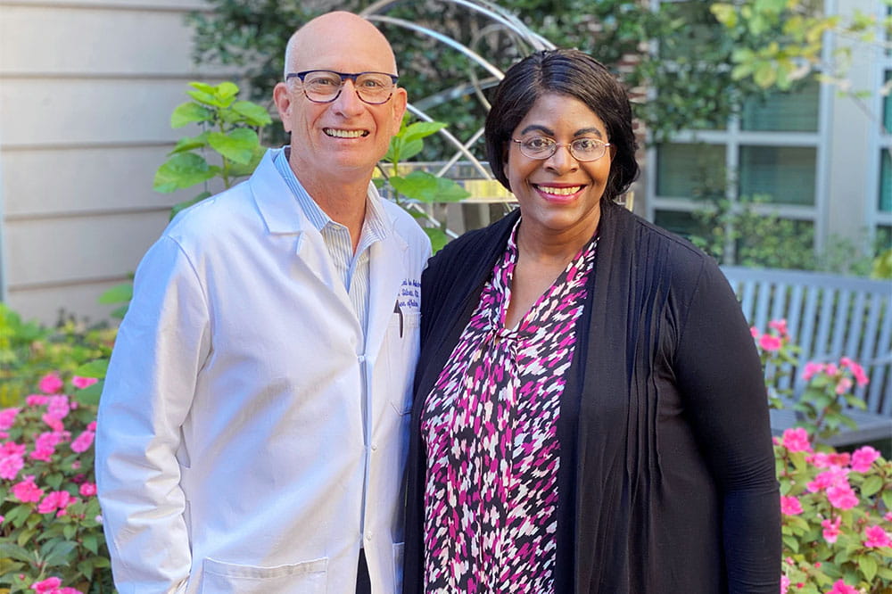 Dr. Gerard Silvestri and Dr. Marvella Ford stand together in a garden