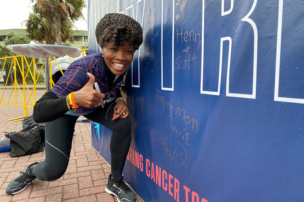 LOWVELO participant Ja'Net Bishop signs the 'Why I Ride Wall.'