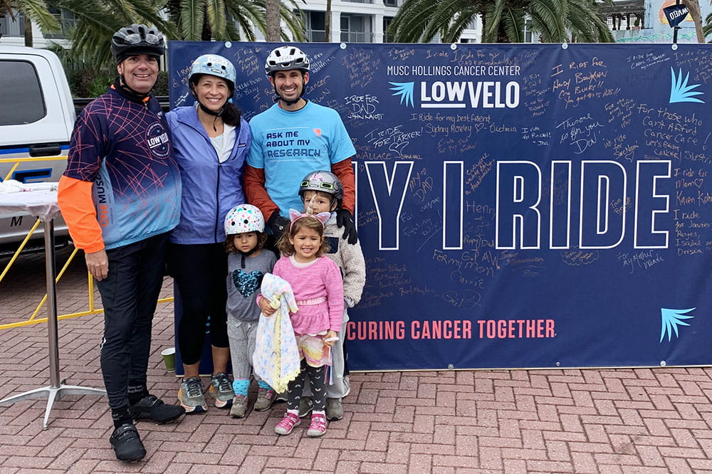 Scott Wentzky with Evan Graboyes and his wife and three kids at the Lowvelo Why I Ride wall
