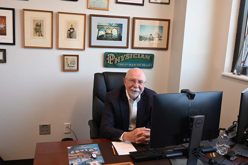 Dr. Kevin Hughes seated at a desk.