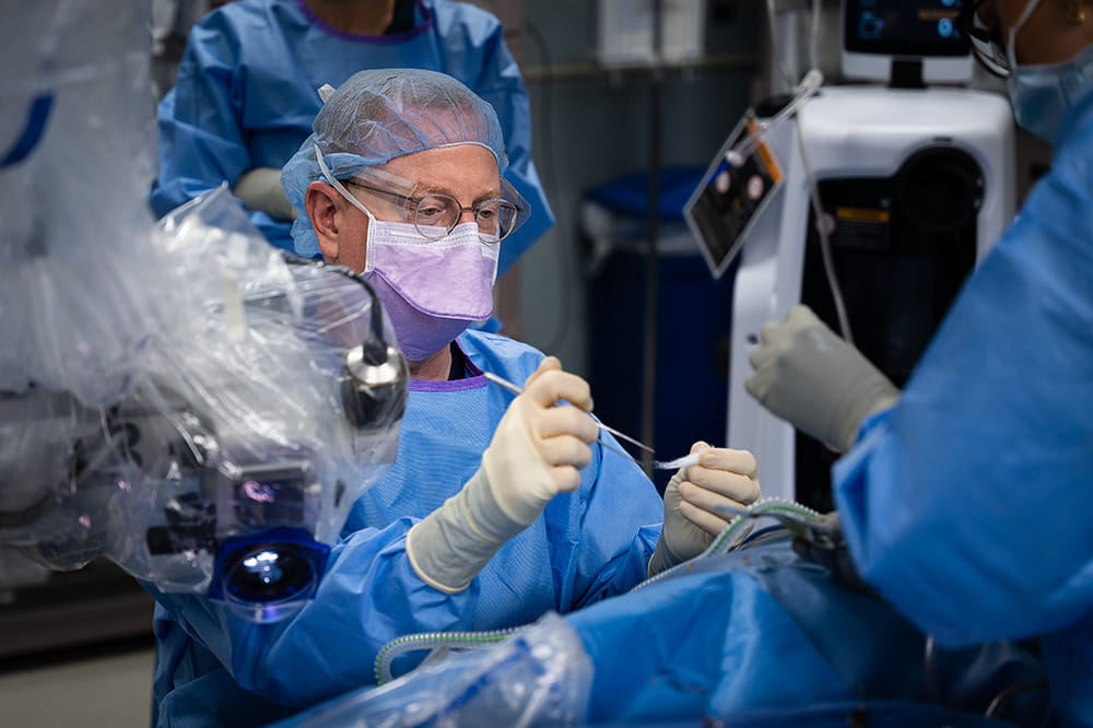 Dr. Robert Labadie performs surgery while two assistants look on