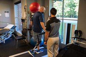 a man with a prosthetic leg walks on a treadmill