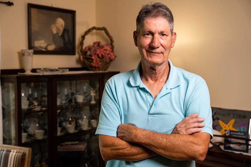 a man poses in his living room 
