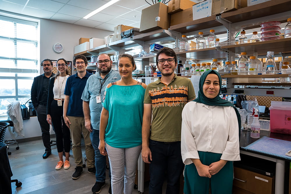 people pose for a group shot in a laboratory