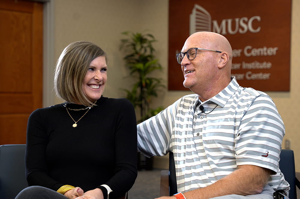 a husband and wife, dual cancer survivors, share a laugh