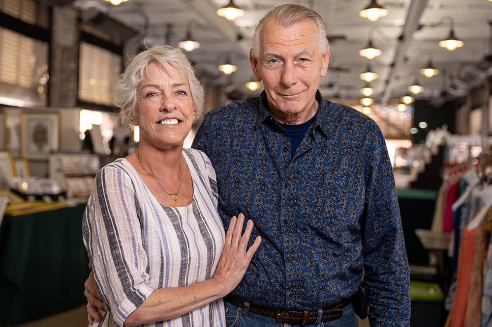 a couple pose in the Charleston market