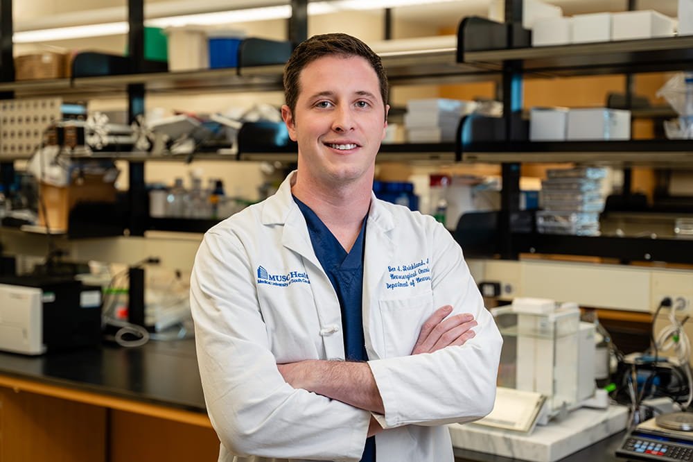 photo of neurosurgeon Ben Strickland in his lab for meningioma research