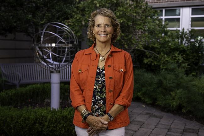 breast cancer survivor Allison Prey poses in a garden setting