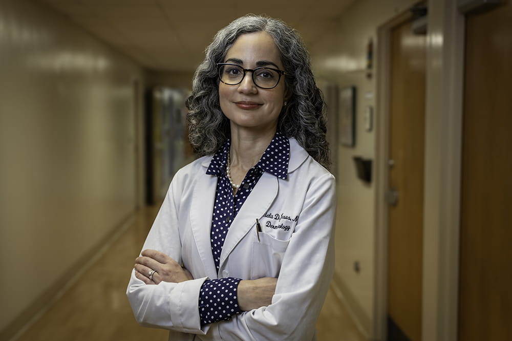 dermatologist Graciela De Jesus poses in the clinic hallway