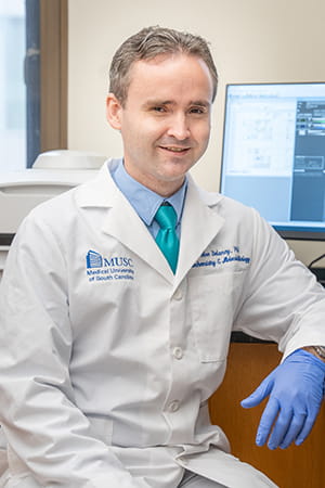 Joe Delaney poses in his lab at MUSC Hollings Cancer Center