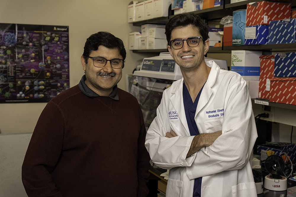 image of a senior scientist and graduate student posing together in the cancer immunology research lab at Hollings Cancer Center