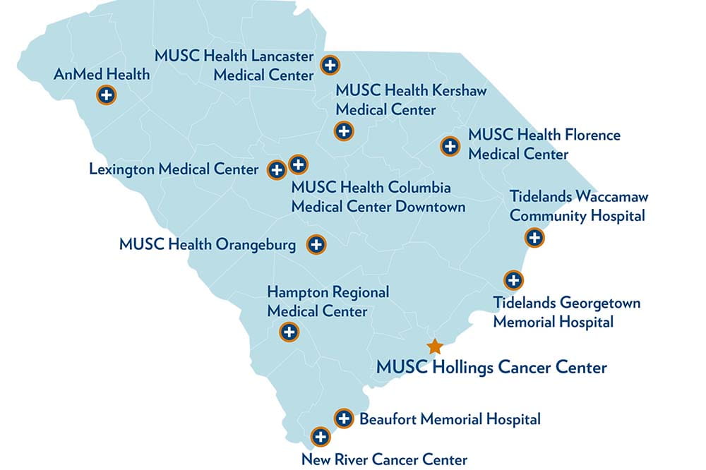 Blue map of South Carolina highlights AnMed Health, Lexington Medical Center, MUSC Health Orangeburg, Hampton Regional Medical Center, Beaufort Memorial Hospital, New River Cancer Center, Beaufort Memorial Hospital, Tidelands Georgetown Memorial Hospital, Tidelands Waccamaw Community Hospital, MUSC Health Florence Medical Center, MUSC Health Kershaw Medical Center, MUSC Health Lancaster Medical Center, MUSC Health Columbia Medical Center Downtown.